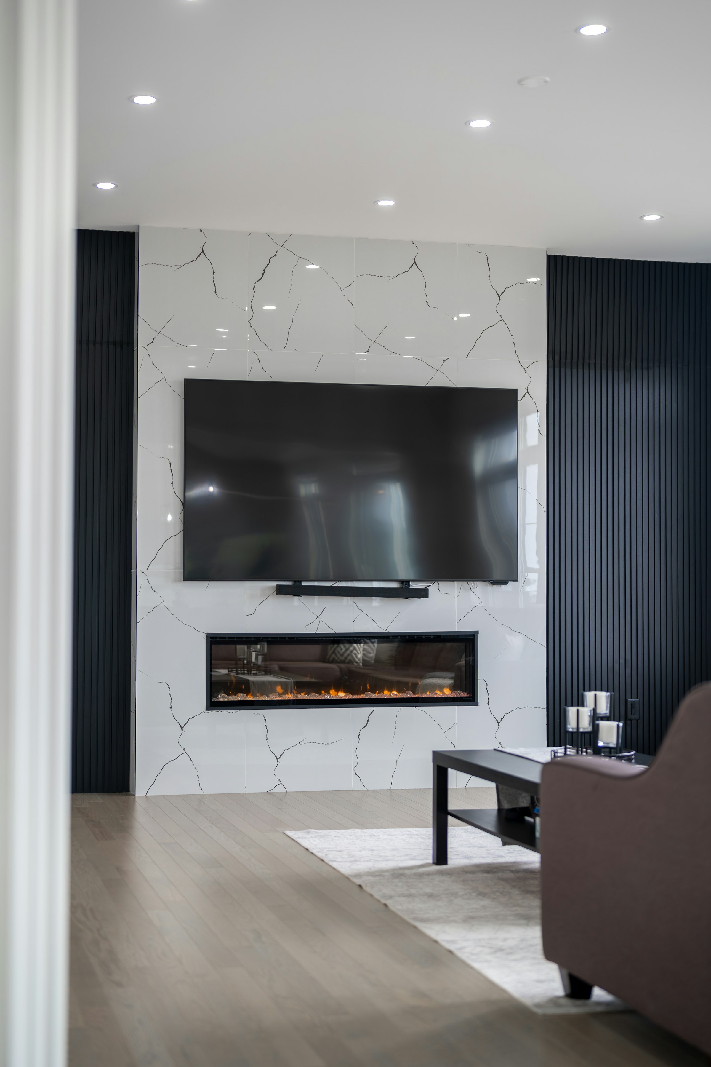Finished living room with a wall-mounted television